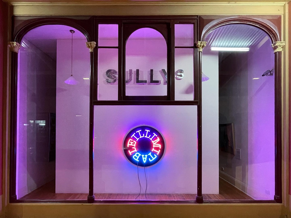 Illimitable meagan streader installation in front window of the gallery underneath the sullys sign