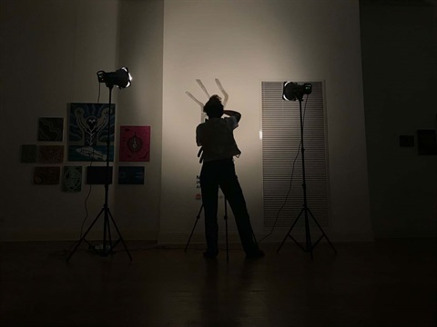 Image of someone photographing in the gallery