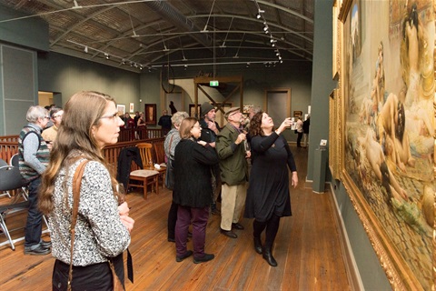 image of visitors looking at artwork vae victis