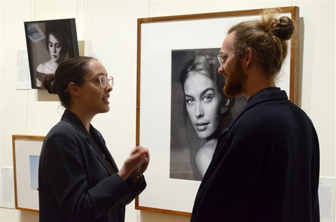 Image of woman and man enjoying an opening night at the gallery