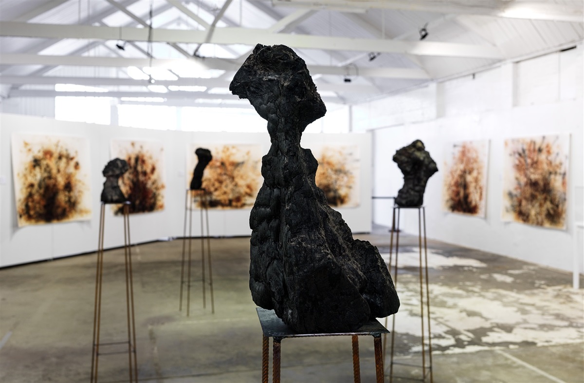 Skeer_Jane_Embedded Landscapes_Out of the Ashes series_2020_burnt and smashed xantthorroea leaves from KI bushfires, on paper_burnt tree stumps on steel_dimensions 2